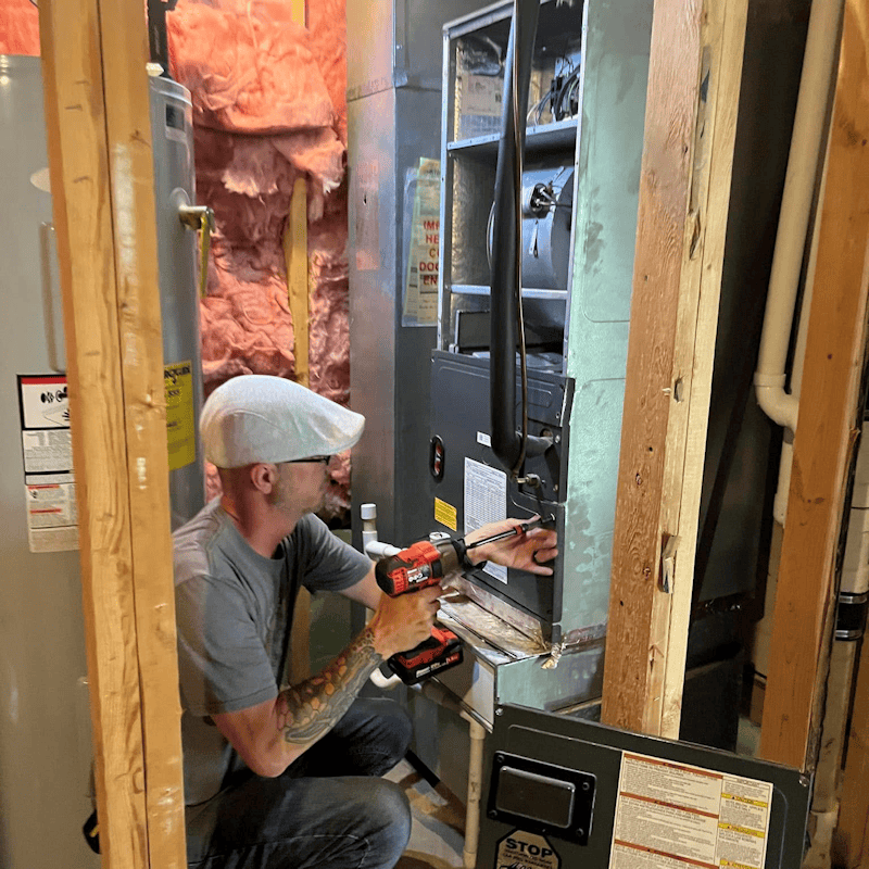 Ireland Heating and Cooling technician replacing a residential furnace